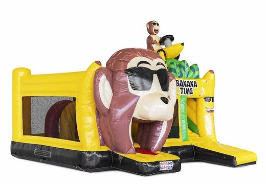 Encomende um castelo inflável inflável com obstáculos e um slide no tema do macaco de banana